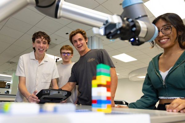 Students using robotic arm in Super Fab Lab